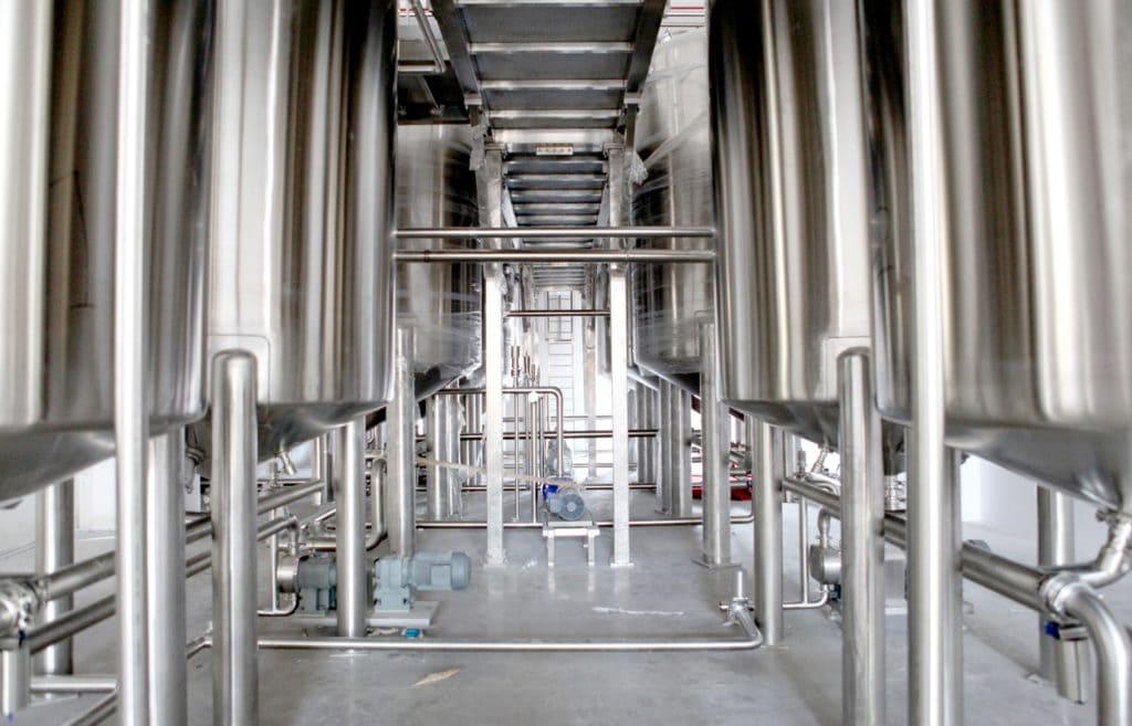 a picture of stainless steel vats in a food and beverage manufacturing facility