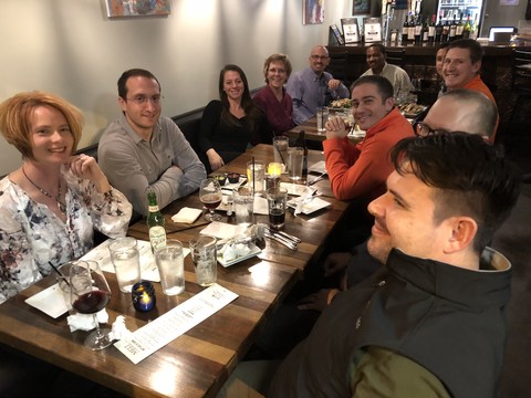 A picture of the Encompass Solutions team and Avalara reps sitting down for drinks and food at melt kitchen and bar in Greensboro, North Carolina.