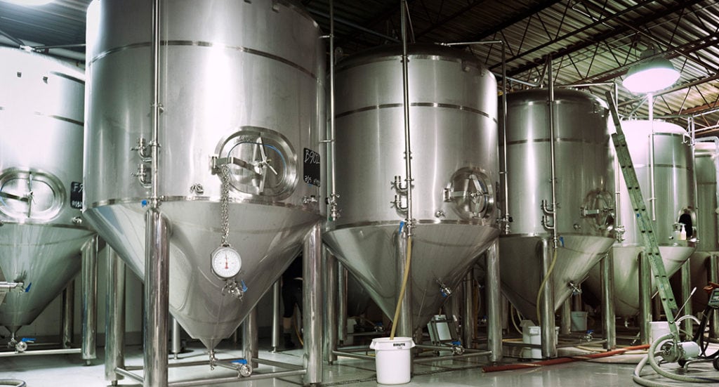 A picture of several vats in a brewery where Non-Alcoholic Beverage Manufacturing takes place.