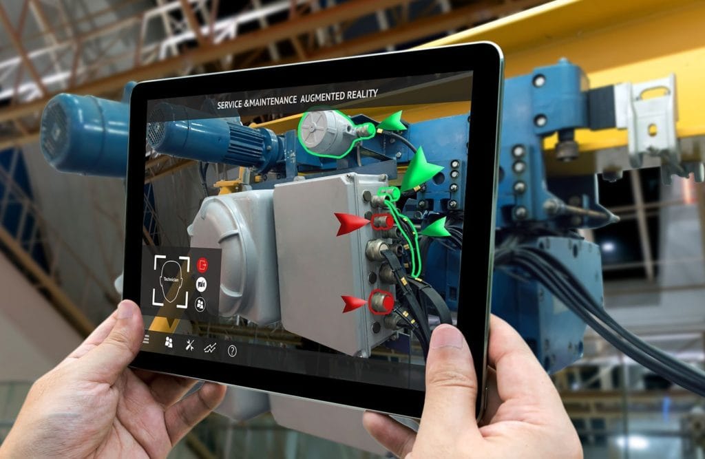 An image of a tablet camera filming a shop floor machine with additional diagrams added via Augmented Reality software.