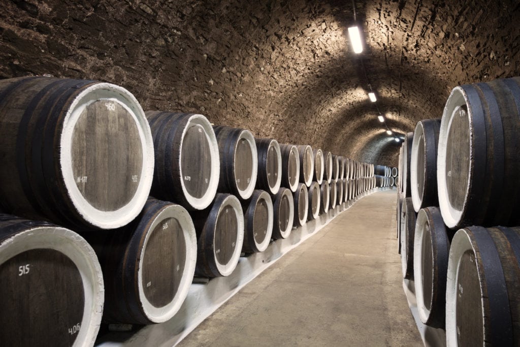 A picture of barrels in the wine cellar, one industry affected by US-China Trade.