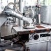 a photo of a robot in a chocolate processing facility