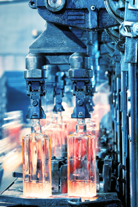 A photograph of bottle being manufactured before labeling and application of mass personalization technology