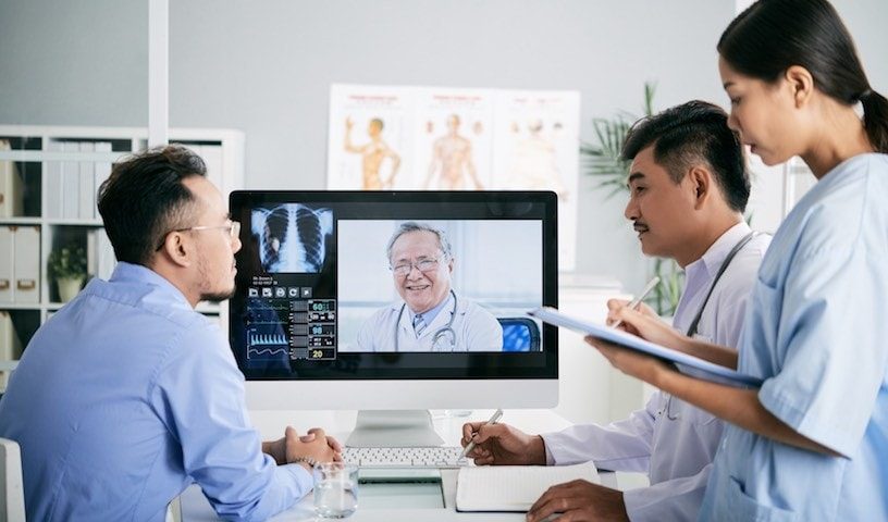 an image of healthcare professionals and patients leveraging 5g wireless technology